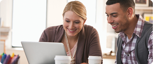 Man and woman working together on a laptop Image